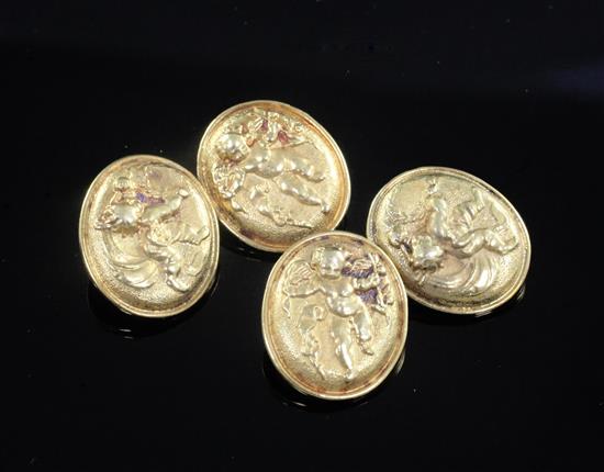 A pair of high carat gold oval cufflinks decorated in relief with cupids,